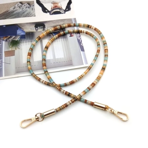 Ethnic style phone lanyard with colorful beads and gold lobster clasps on white background