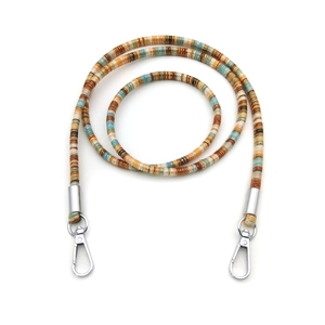 Close-up of bohemian style woven lanyard with silver metal swivel hooks and carabiners