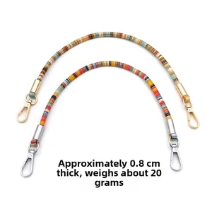 Detailed view of bohemian woven bag straps featuring durable colorful rope and metal lobster clasps