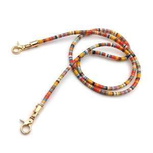 Colorful bohemian beaded bag strap with gold lobster clasps on plain white background