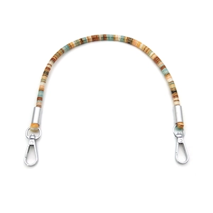 Close-up of ethnic woven pattern strap with polished silver rotating metal clasps