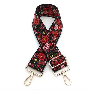 Close-up of vintage ethnic floral embroidery on adjustable black wide bag strap