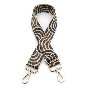 Adjustable woven shoulder strap with retro taupe wave pattern and gold metal hooks