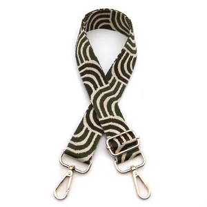 Adjustable woven replacement bag strap with olive green wavy patterns and gold metal buckles