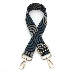 Detailed close-up of woven bag strap No. 17 with blue and grey wave patterns and gold buckle
