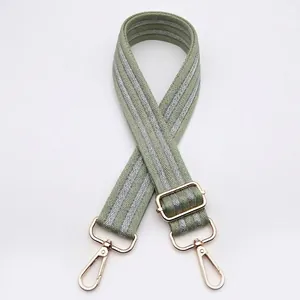 Adjustable wide replacement bag strap with light green herringbone pattern and gold clips