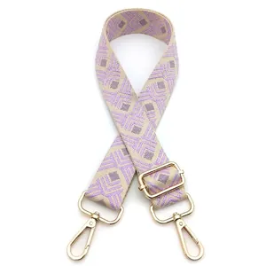 Detail view of woven purple and beige geometric diamond pattern on wide guitar style bag strap