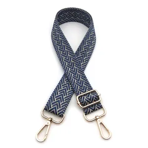 Detail view of navy and beige chevron woven strap with gold metal lobster hooks