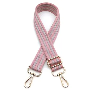 Adjustable wide replacement bag strap with pink and grey stripes and gold buckles