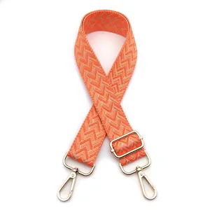 Detail of adjustable 3.8cm wide orange and beige V-pattern strap with gold metal lobster clasp