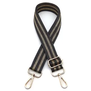 Adjustable black and brown herringbone patterned strap with gold hardware hooks