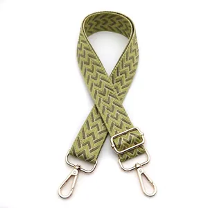 Detail view of 3.8cm adjustable green and beige wavy woven strap with gold metal buckles