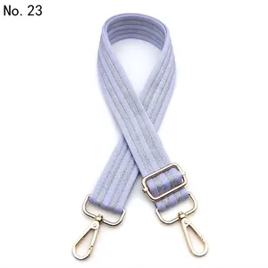 Adjustable lavender woven shoulder strap with silver herringbone pattern and gold clips