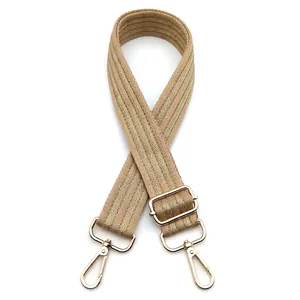 Detailed view of khaki herringbone strap with light gold swivel hooks and metal buckle