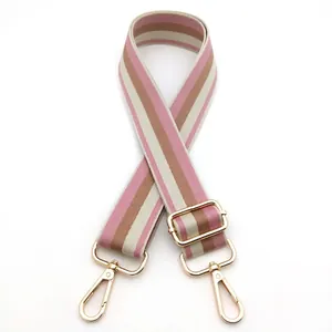 Adjustable striped shoulder strap with pink and khaki weave and gold metal hooks