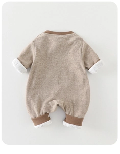 Detail view of oatmeal baby romper back with ribbed brown trim and soft cotton texture