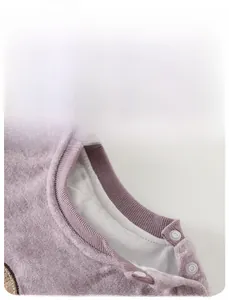 Detail view of cotton baby bodysuit with ribbed collar and shoulder snap buttons in purple
