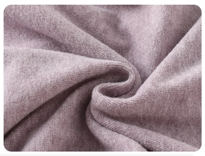 Close-up of soft lilac knit fabric texture for baby rompers with detailed fiber weave
