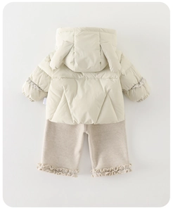 Detail of baby winter coat with cute bunny ears on hood and quilted texture