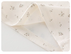 Detail of floral ribbed cotton fabric showing fine stitching and soft texture for kids jacket