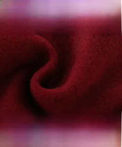 Detail of high-density red wool fabric showing soft texture and anti-pilling quality