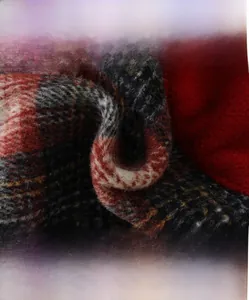 Detail of red and grey checkered wool fabric showing soft brushed texture and thick weave