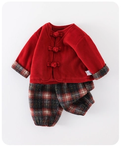 Detail view of red fleece jacket with traditional Chinese knots and plaid pants