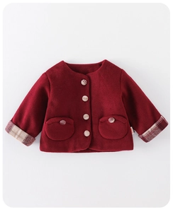 Detail of red winter fleece jacket for baby girls with checkered cuffs and round pockets