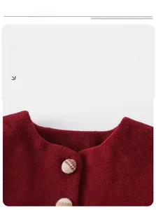 Detail of round collar and plaid buttons on burgundy wool-like festive toddler jacket