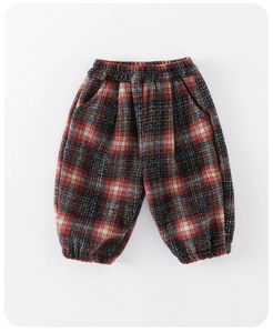 Detail view of red and black plaid toddler trousers with elastic waist and ribbed cuffs
