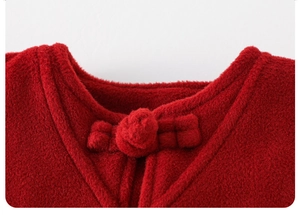 Detailed close-up of a red plush winter vest featuring traditional Chinese knot button detail