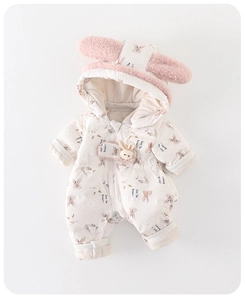 Detail of white baby puffer romper with pink rabbit prints and 3D plush bunny toy