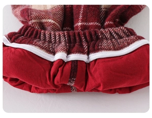 Detailed macro view of red checkered wool fabric and warm lining of the baby winter suit