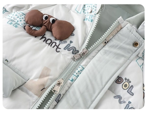Detail of baby down suit featuring a 3D elephant patch and smooth dual metal zippers