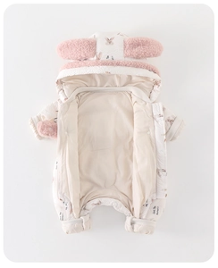 Detail of baby hooded romper featuring pink fuzzy bunny ears and heart pattern print