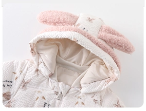 Detail of baby quilted down romper with cute rabbit ears hood and rabbit print pattern