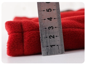 Detail shot of 15mm thick red wool fabric showing warm texture and premium material density