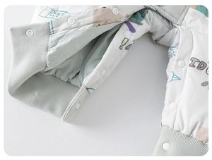 Detail of baby down romper with colorful cartoon prints and snap buttons at the crotch