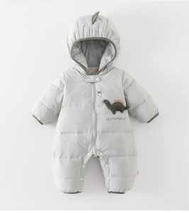 Detail of baby winter jumpsuit featuring a dinosaur patch and snap buttons for easy changing