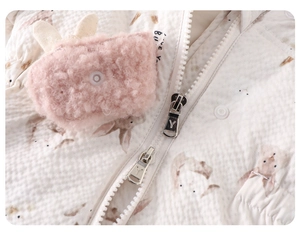 Detail of baby down romper showing double metal zippers and pink plush bunny pocket