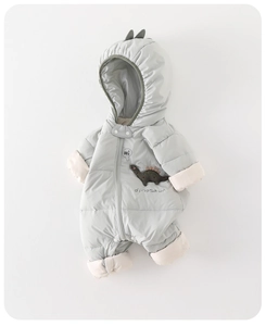 Detail of grey baby winter romper showing dinosaur hood spikes and quilted warm texture