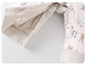 Detail of baby romper featuring waffle texture fabric with bunny print and secure zipper