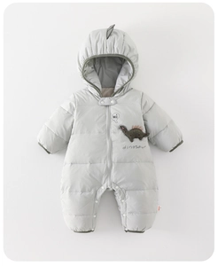 Detail of light grey quilted baby romper featuring a cute dinosaur hood and embroidery