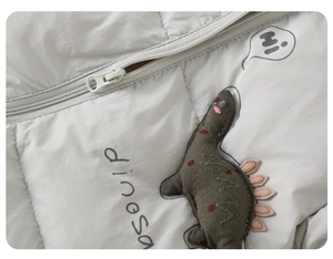 Close-up of baby winter romper with dinosaur embroidery and high-quality zipper detail