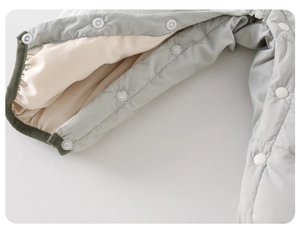 Detail view of winter baby romper with high-quality white snap buttons and beige lining