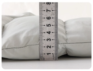 Detail showing the 5.5cm thickness of this warm winter baby romper with fleece lining