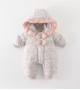 Detail of floral infant hooded puffer romper with pink ruffles and soft 3D bow accents