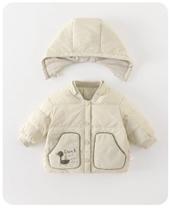 Detail of beige quilted toddler jacket featuring cartoon duck pocket and snap buttons