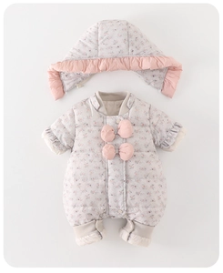 Detail of floral baby winter romper with pink bow and quilted insulated fabric