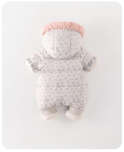 Detail of baby snowsuit with pink floral pattern, ruffled hood and elastic cuffs
